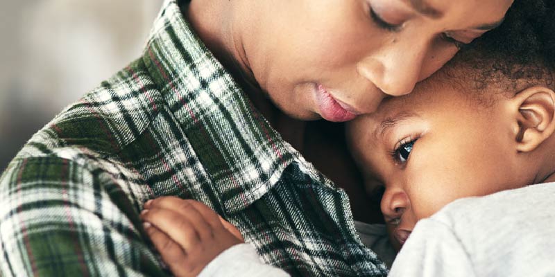 Woman holding a baby.