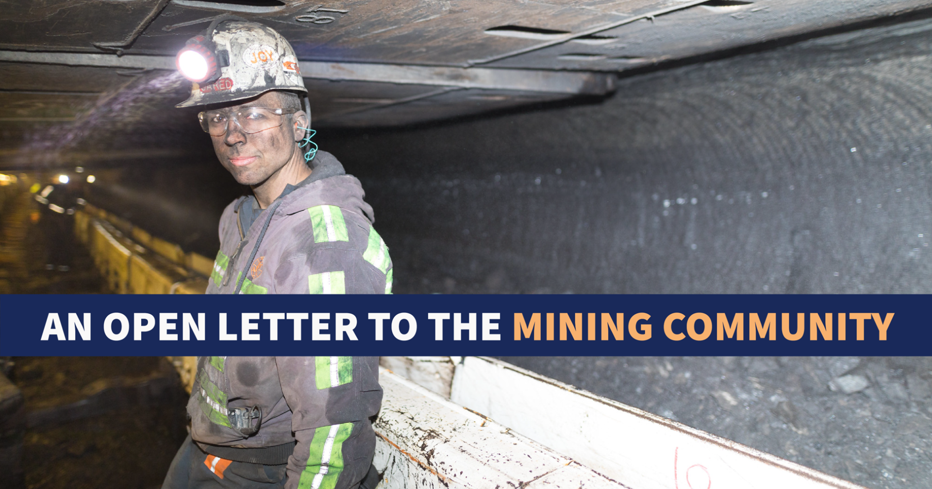 Miner underground with dust on their face. There is a blue banner across the middle that reads "An open letter to the mining community"