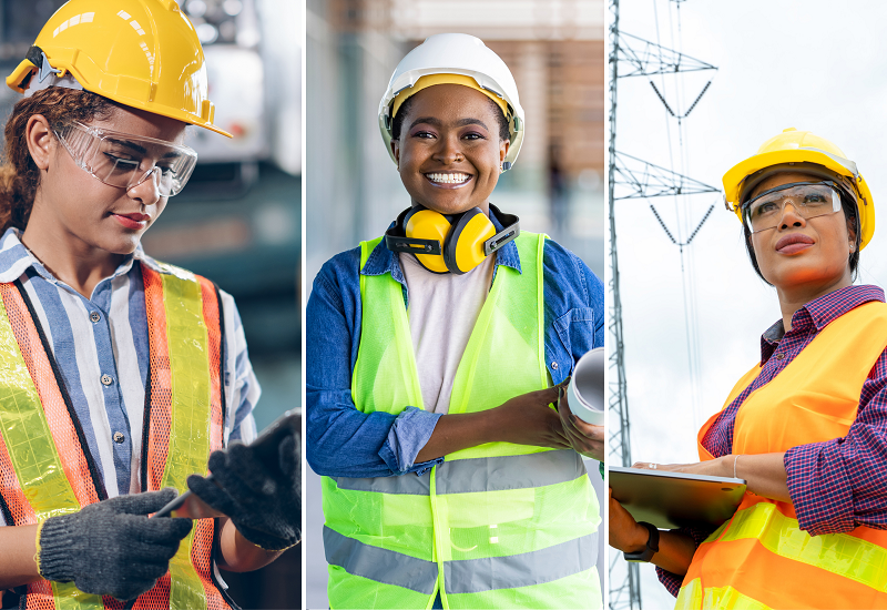 Three diverse women construction workers wearing a variety of protective gear, such as hard hats, ear protection, safety goggles, high-visibility vests and gloves.