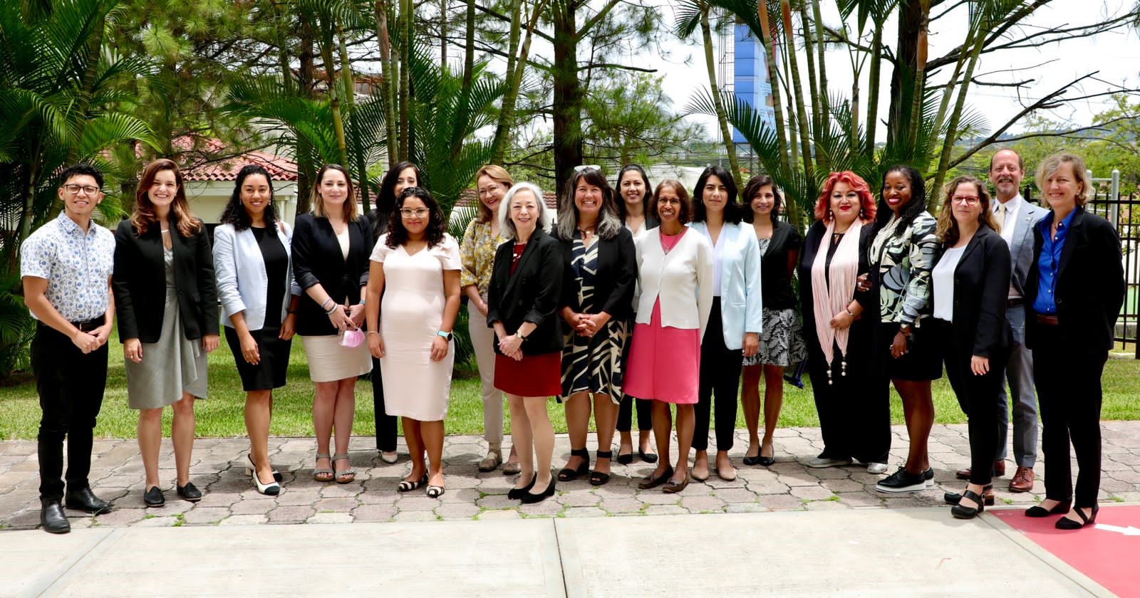 Thea Lee in a group photo with several other women and men standing outside